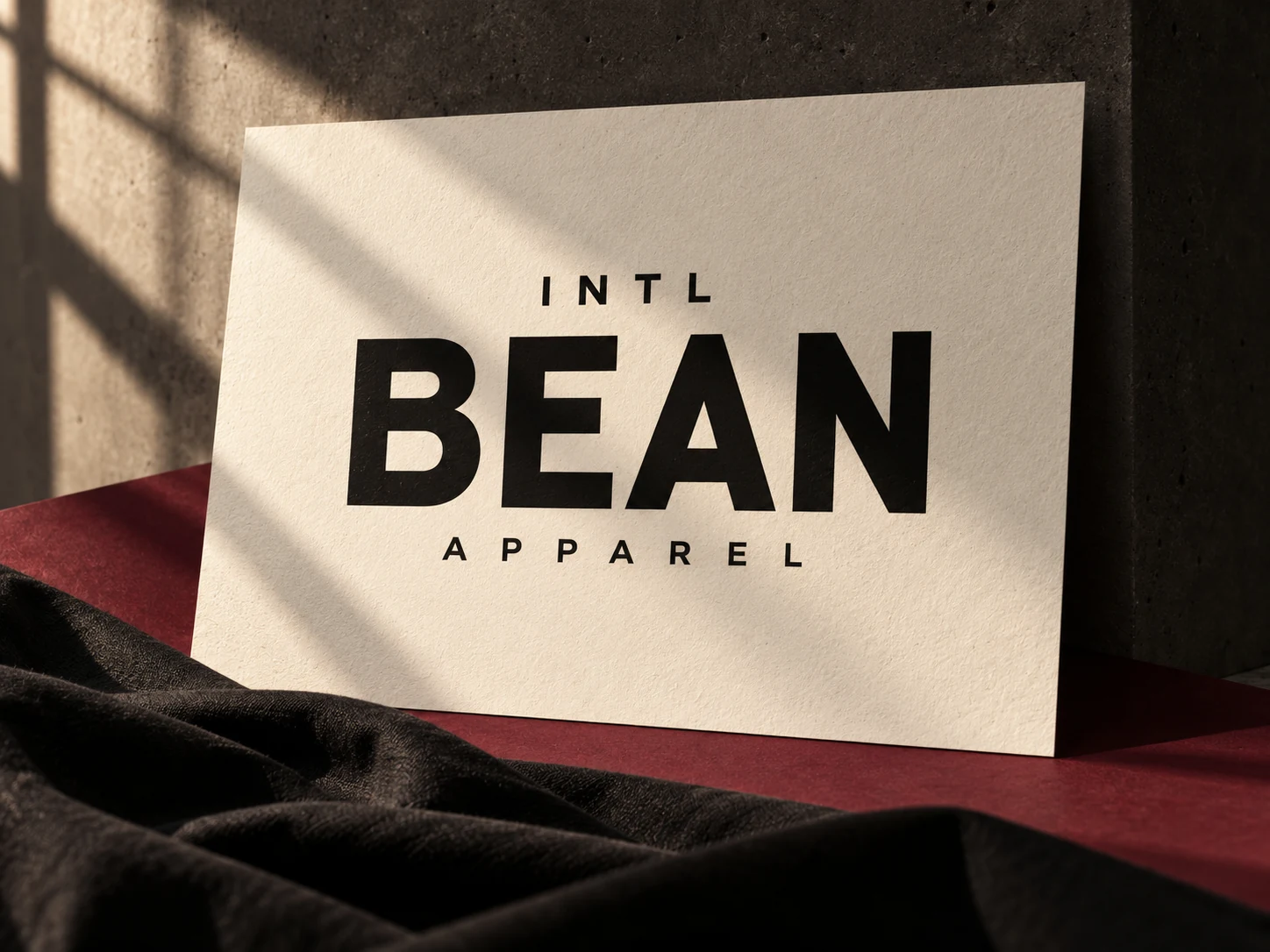 INTL Bean Apparel sign with charcoal fabric in warm sunlight